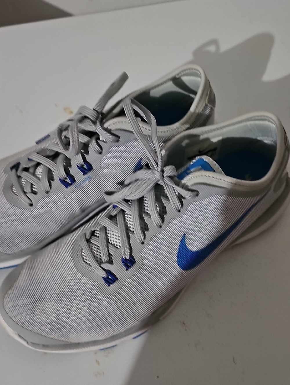 Nike Gray Sneakers with Blue Swoosh